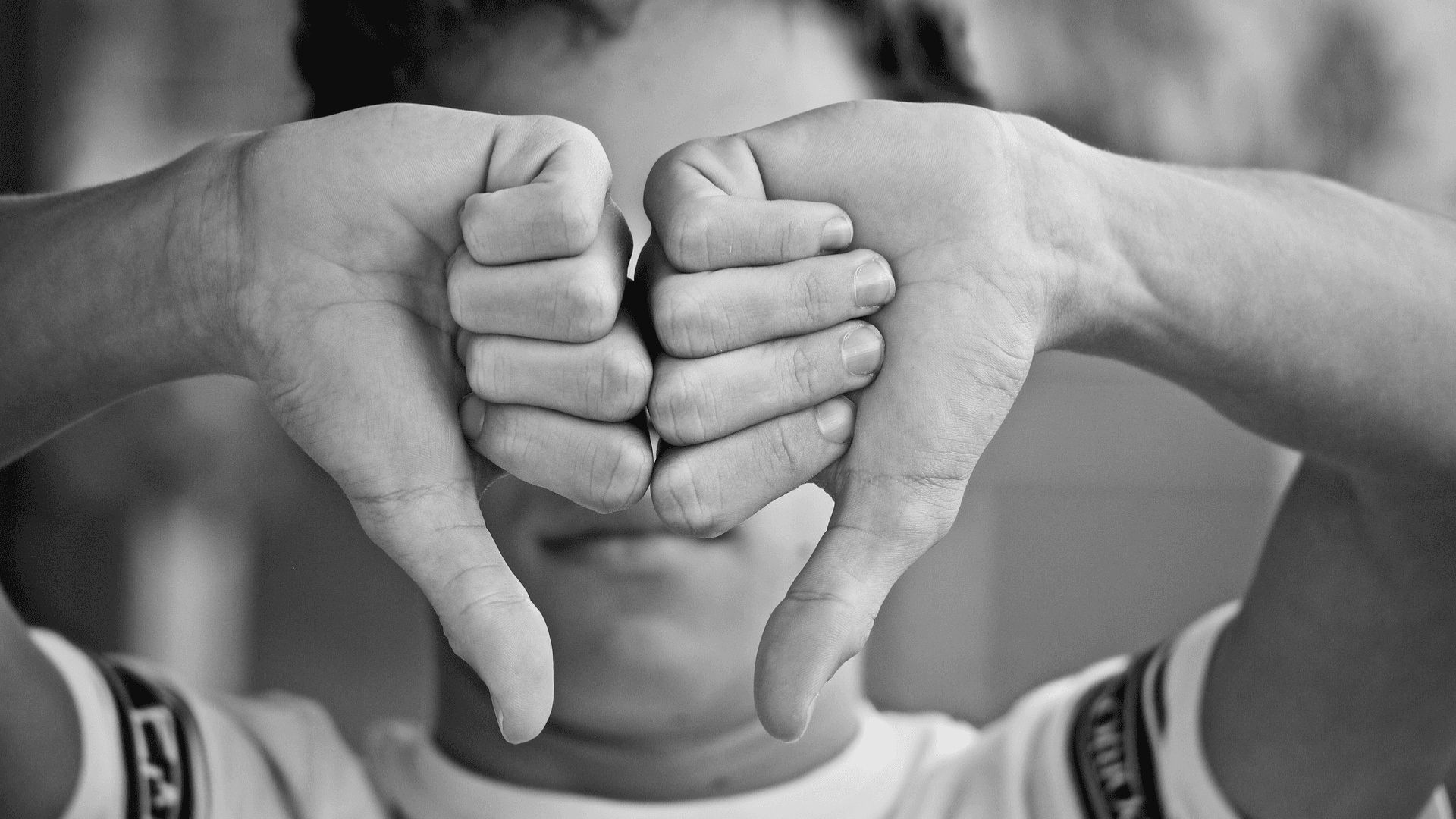 kid giving a double thumbs down